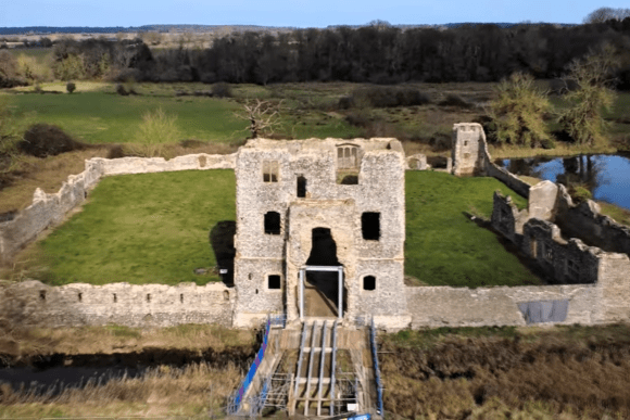 Aerial view of Baconsthorpe Castle ruins with surrounding moat and countryside in Norfolk, England