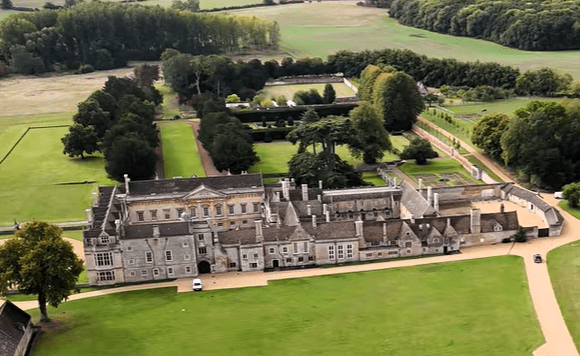Aerial view of Apethorpe Palace showing the historic mansion, formal gardens, and surrounding countryside.