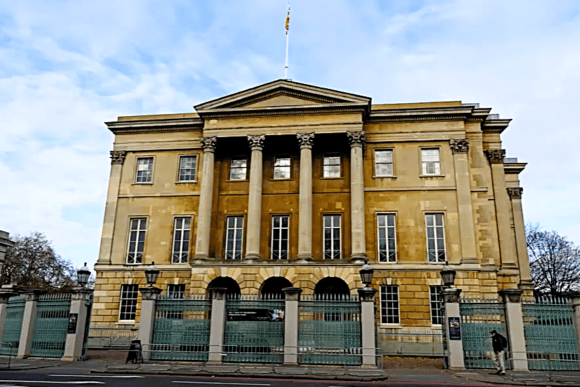 Apsley House in London, a grand neoclassical mansion with tall columns and a gated frontage.
