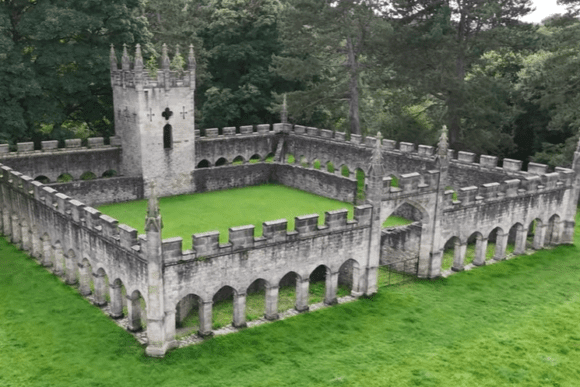 Aerial view of the Deer House at Auckland Castle with stone arches and central tower in County Durham, England