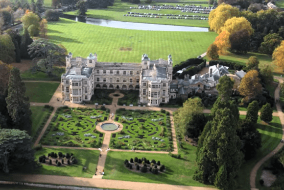 Aerial view of Audley End House with formal parterre gardens and parkland in Saffron Walden, Essex