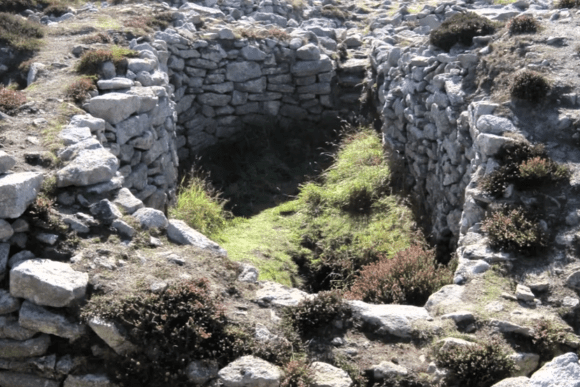 Interior view of Ballowall Barrow Bronze Age burial cairn showing stone chamber and entrance in Cornwall