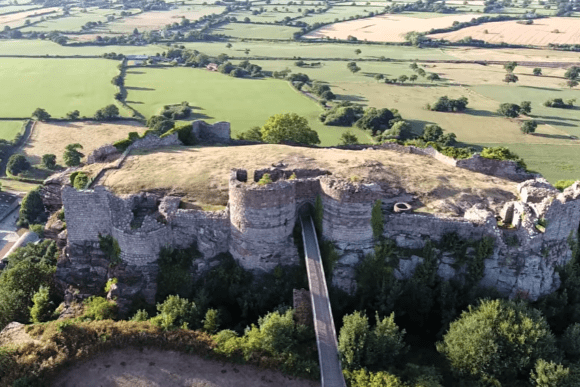 Aerial view of Beeston Castle ruins on a rocky hilltop overlooking the Cheshire countryside