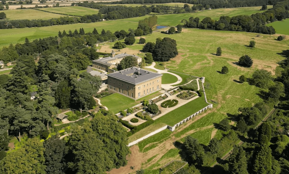 Aerial view of Belsay Hall with formal gardens and surrounding countryside