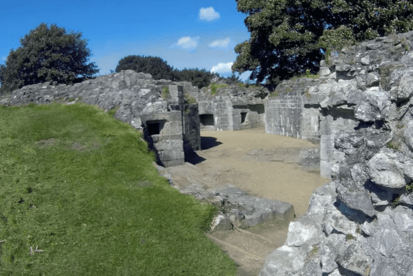 Stone ruins of a defensive gun battery at Berwick-upon-Tweed, set beneath grassy earthworks on a sunny day.