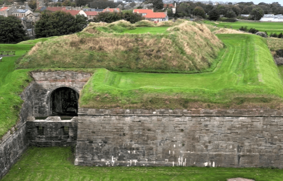 Aerial view of the stone ramparts and grassy earthworks of Berwick-upon-Tweed’s historic fortifications.
