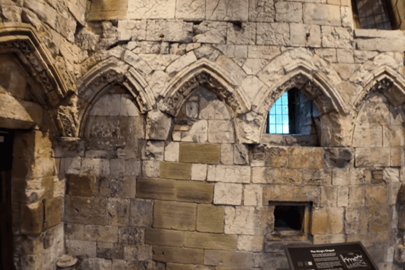 Medieval stone arches and wall details inside Clifford's Tower in York.