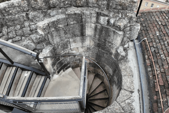 Spiral stone staircase descending inside Clifford's Tower, York.