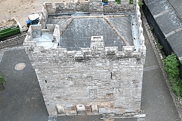 Aerial view of the crenellated stone tower roof at Clifton Hall.