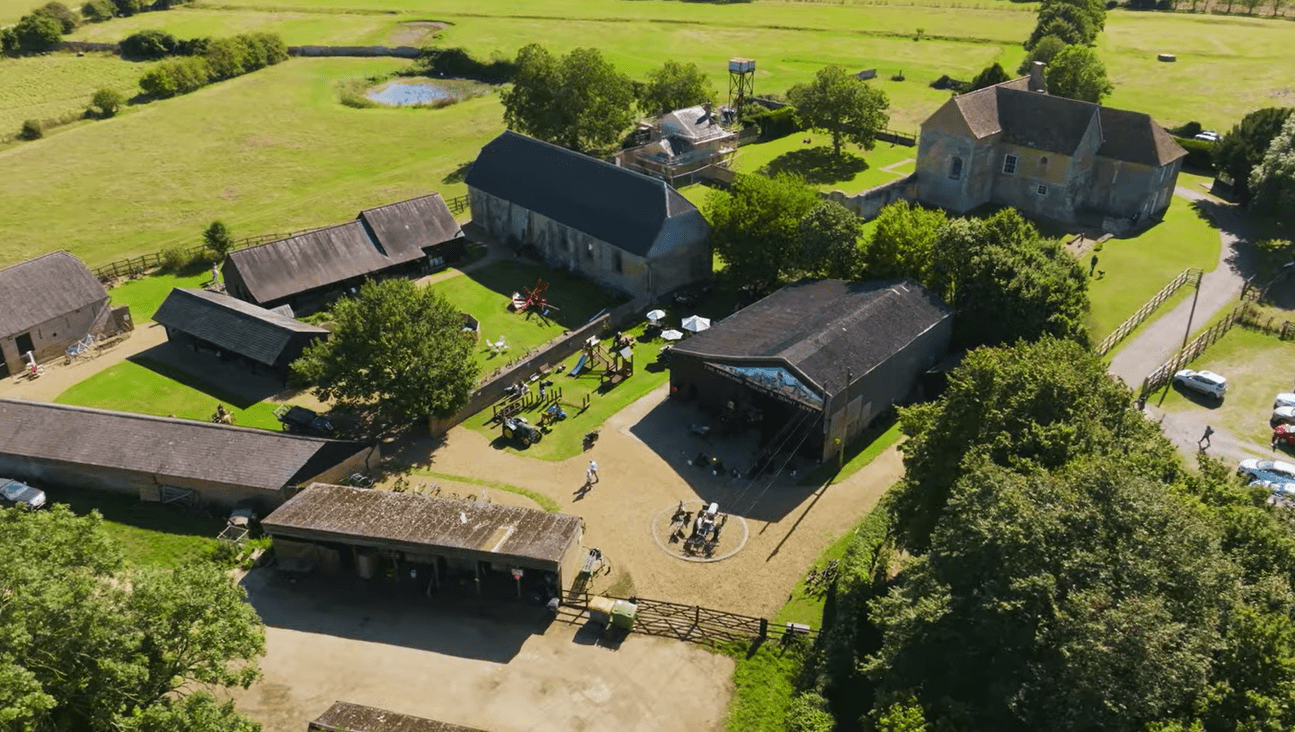 Aerial view of Denny Abbey & Farmland Museum showing historic farm buildings, open courtyards, and surrounding countryside.