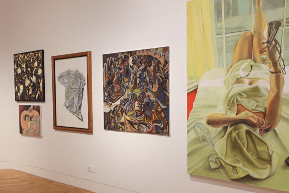 Artwork display at Ferens Art Gallery in Hull featuring contemporary paintings, figurative art, abstract compositions, and mixed-media works showcased on a modern gallery wall.