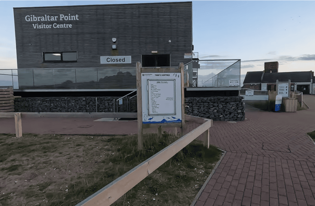 Gibraltar Point National Nature Reserve Visitor Centre entrance with information board and modern visitor facilities in Lincolnshire, overlooking one of England’s premier coastal nature reserves.