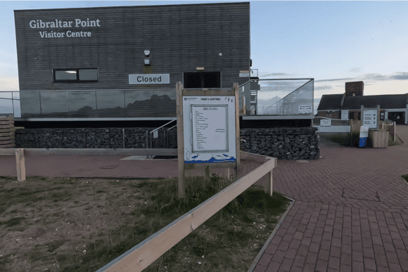 Gibraltar Point National Nature Reserve Visitor Centre entrance with information board and modern visitor facilities in Lincolnshire, overlooking one of England’s premier coastal nature reserves.