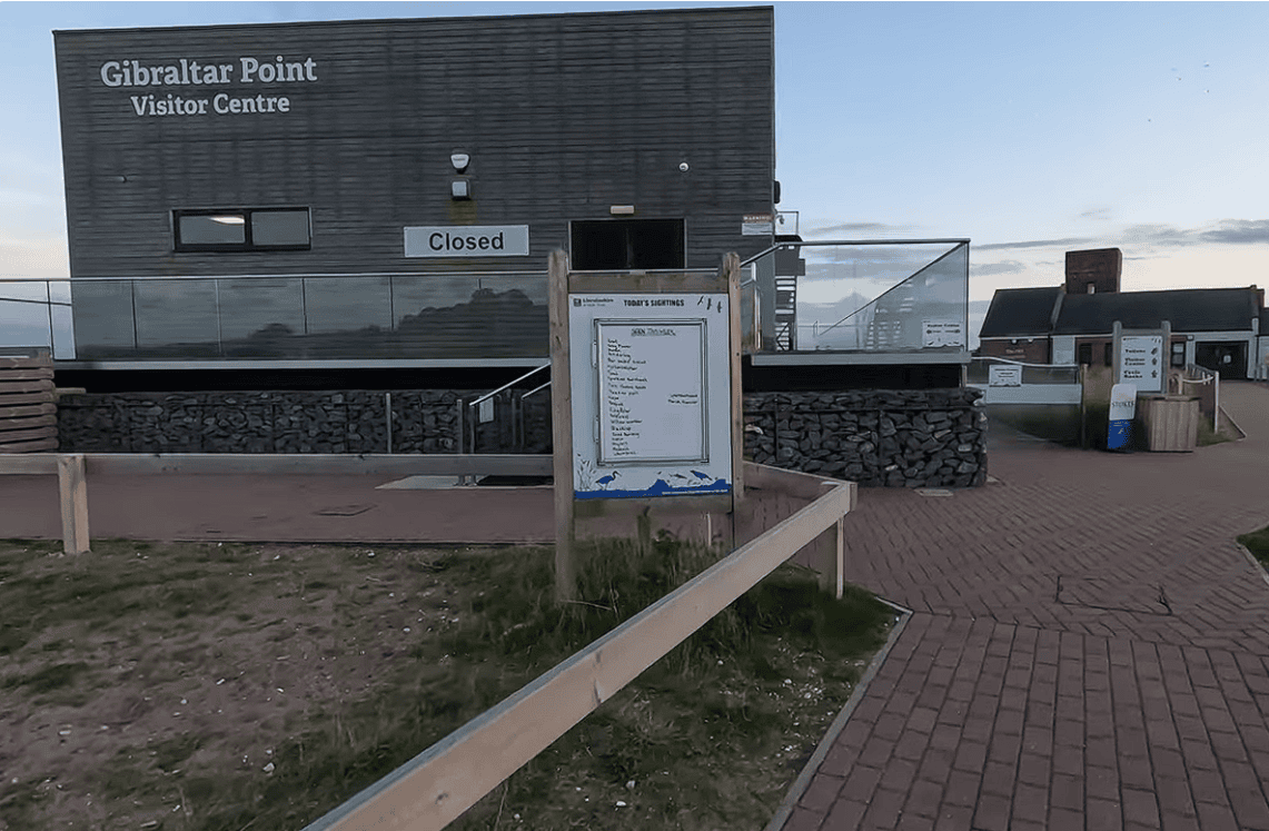 Gibraltar Point National Nature Reserve Visitor Centre entrance with information board and modern visitor facilities in Lincolnshire, overlooking one of England’s premier coastal nature reserves.