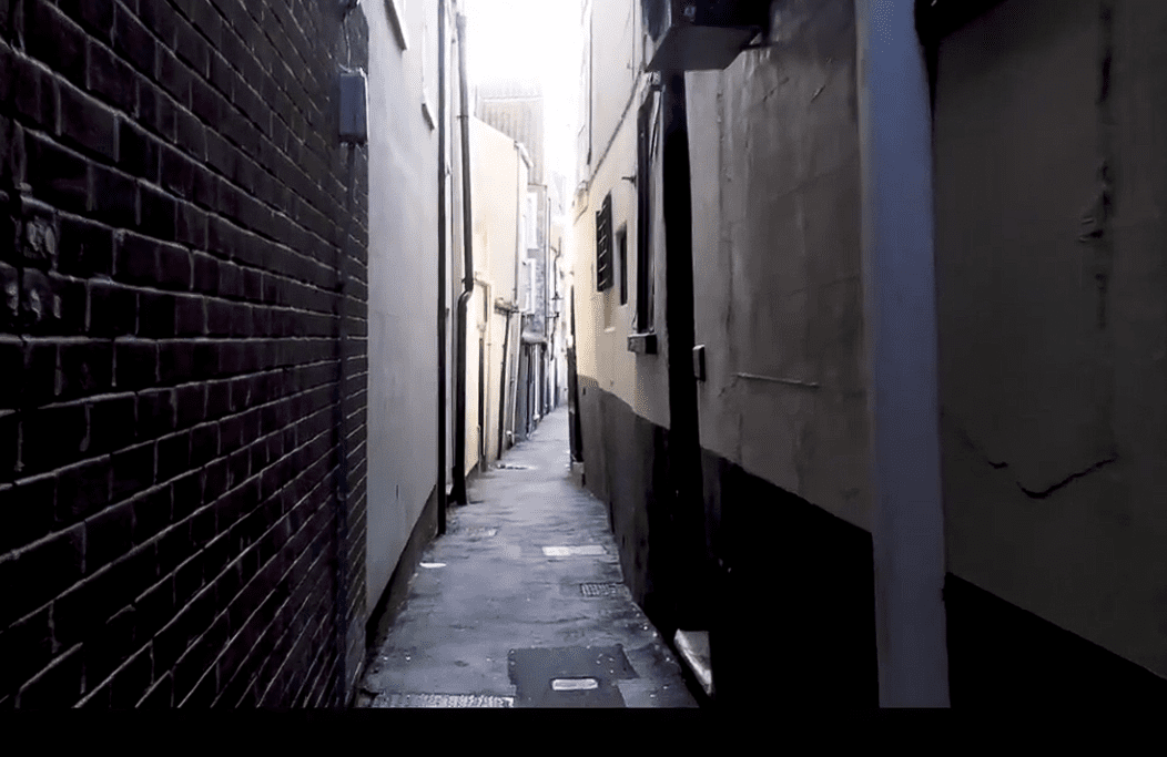 Narrow historic alleyway between tall buildings in Great Yarmouth, showing the tight passage typical of the town’s row houses.