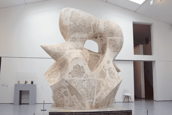 Large abstract stone sculpture by Henry Moore displayed in a bright gallery space at the Henry Moore Institute in Leeds, showcasing the artist’s signature organic forms and monumental modernist style.