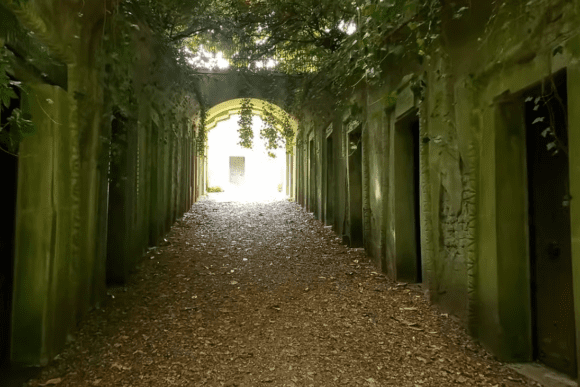 Ivy-covered corridor of tombs in the Egyptian Avenue at Highgate Cemetery.