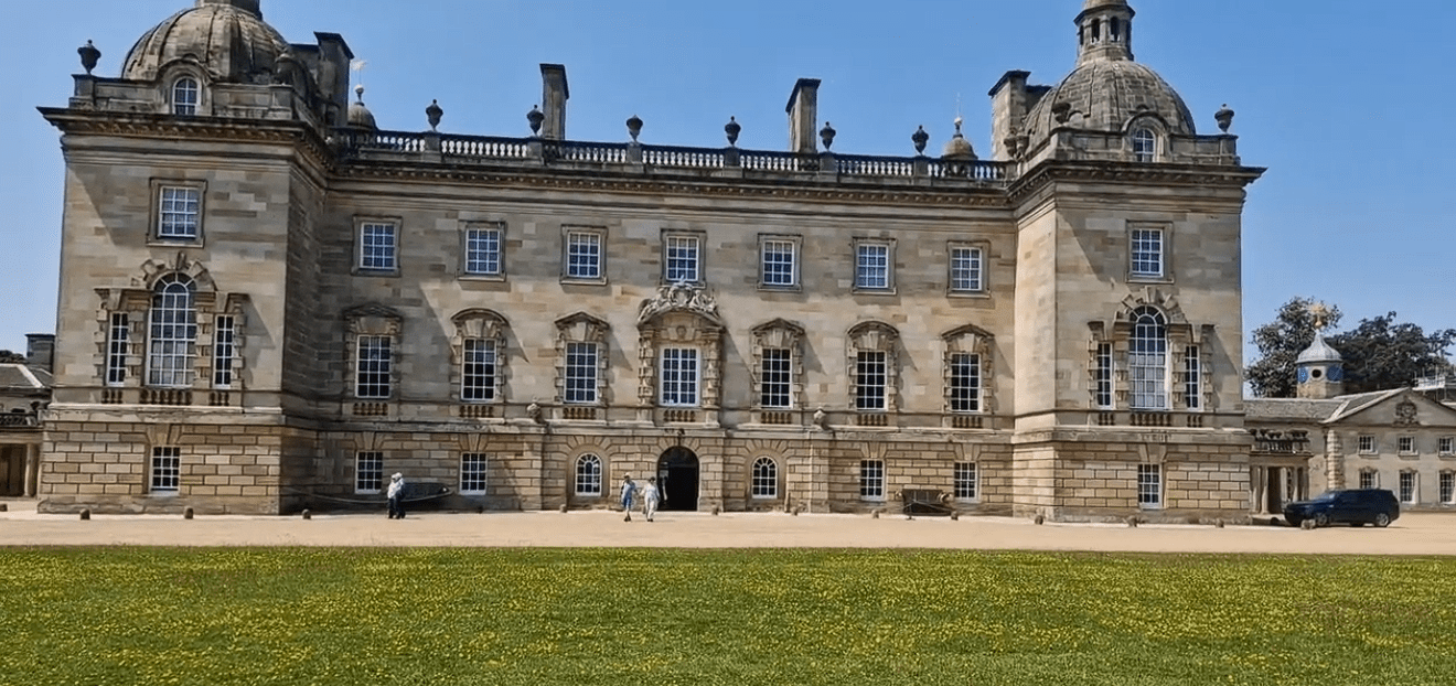 Houghton Hall stately home with symmetrical façade and domed corner towers in Norfolk.