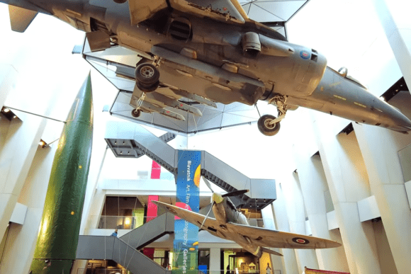 Historic military aircraft suspended inside the atrium of the Imperial War Museum London.