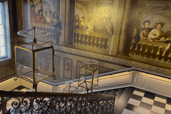 Decorative staircase inside Kensington Palace with painted murals and hanging lanterns.