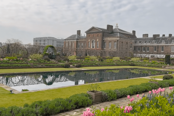 Kensington Palace with formal gardens and reflecting pond in Kensington Gardens, London.