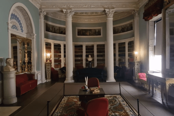 Elegant library room at Kenwood House with columns, bookshelves, and classical decoration.