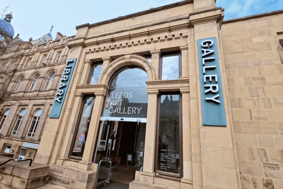 Exterior entrance of Leeds Art Gallery in Leeds city centre, featuring its historic stone façade, arched doorway, and prominent gallery signage on a landmark cultural building.