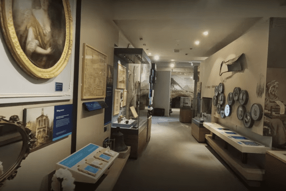 Historic Leeds City Museum gallery displaying local heritage exhibits, archival documents, maps, portraits, and interactive displays that explore the history and cultural development of Leeds.