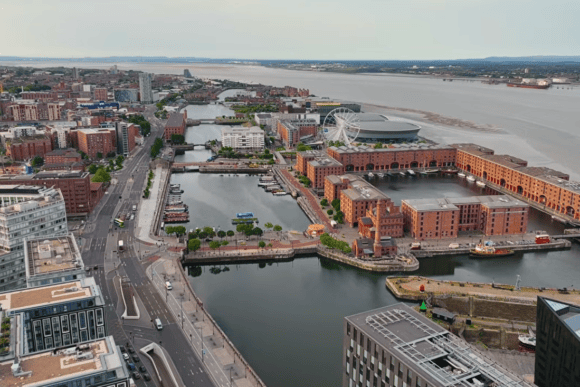 Aerial view of Liverpool waterfront and Royal Albert Dock, with historic warehouses, docks, the Wheel of Liverpool and River Mersey.