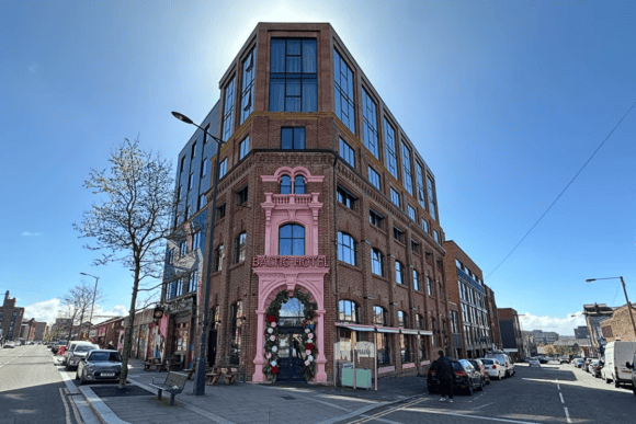 Baltic Hotel in Liverpool’s Baltic Triangle, featuring a restored red-brick façade with distinctive pink detailing and modern upper floors.
