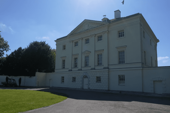 Exterior view of Marble Hill House, a pale neoclassical villa with symmetrical façade and columns.