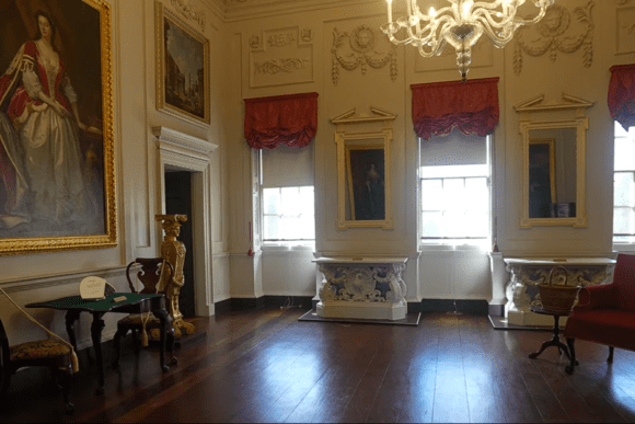 Elegant Georgian interior room at Marble Hill House with chandelier, portraits, and period furniture.