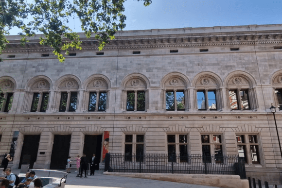 Exterior of the National Portrait Gallery with ornate stone façade and arched windows.