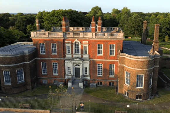Ranger’s House in Greenwich, London, showing a red-brick Georgian mansion with symmetrical façade, large windows, and surrounding gardens.