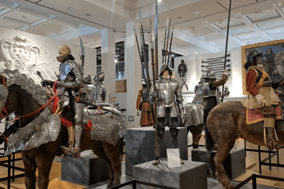 Medieval and Renaissance armour display at the Royal Armouries Museum in Leeds, featuring mounted knights in full plate armour, cavalry equipment, lances, and historic weapons from Europe’s military past.