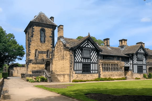 Shibden Hall historic timber-framed house with stone tower, traditional Tudor architecture, and landscaped grounds in Halifax.