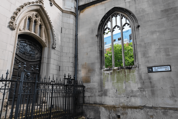 St Dunstan in the East London exterior with Gothic stone doorway, arched window, and iron railings on St Dunstan’s Hill.