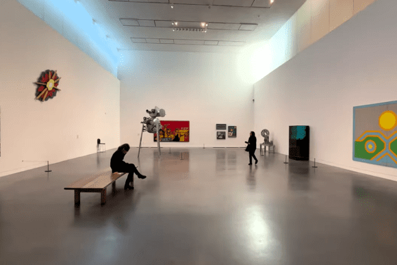 Contemporary art gallery inside Tate Modern in London featuring modern paintings, sculptures, open exhibition space, and visitors viewing artworks.