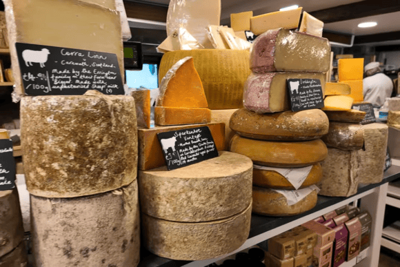 Display of artisan Yorkshire cheeses at The Courtyard Dairy featuring mature farmhouse cheeses, traditional cheese wheels and handcrafted regional varieties.