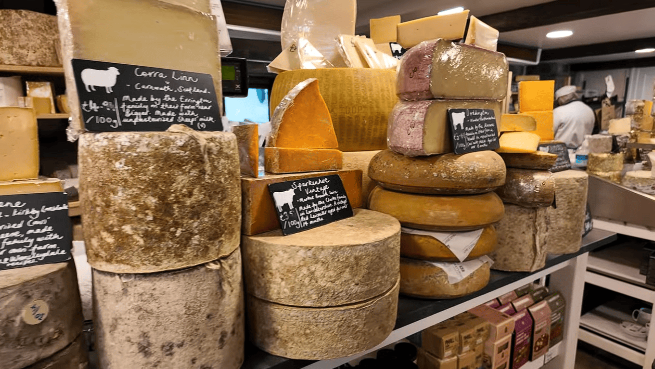 Display of artisan Yorkshire cheeses at The Courtyard Dairy featuring mature farmhouse cheeses, traditional cheese wheels and handcrafted regional varieties.
