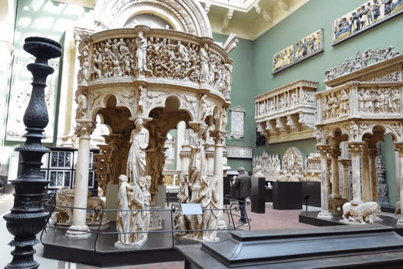 Intricately carved Renaissance sculptures and marble architectural displays inside the Victoria and Albert Museum in London, featuring historic Italian art and ornate gallery interiors.