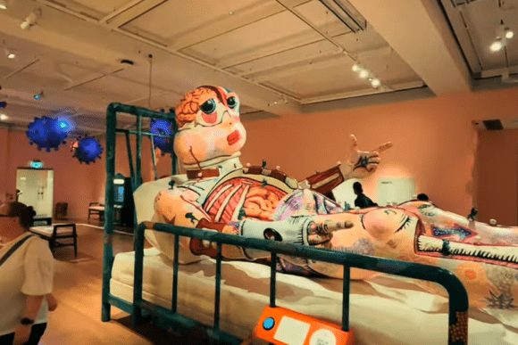 Large anatomical sculpture displayed at the Wellcome Collection in London, featuring exposed organs and colourful artistic details within an immersive exhibition exploring health, medicine, and the human body.