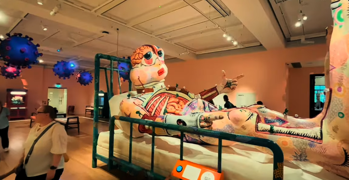 Large anatomical sculpture displayed at the Wellcome Collection in London, featuring exposed organs and colourful artistic details within an immersive exhibition exploring health, medicine, and the human body.