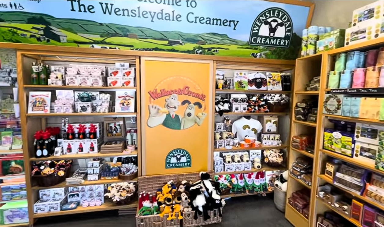Gift shop at Wensleydale Creamery Visitor Centre featuring Wallace and Gromit merchandise, souvenirs, gifts, and Wensleydale Creamery products in Yorkshire.
