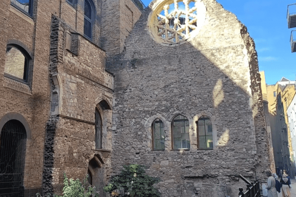 Historic ruins of Winchester Palace in London featuring medieval stone walls, Gothic arched windows, and the famous rose window near Borough Market.