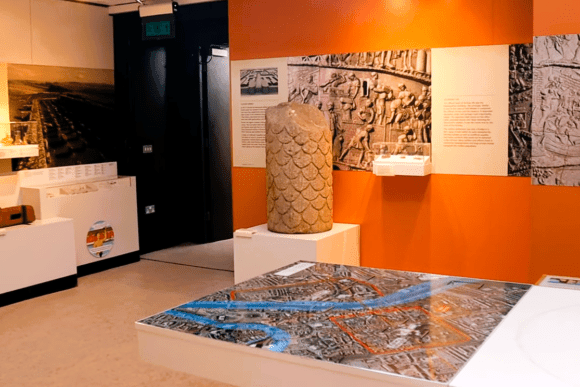 Archaeology and history exhibit at Yorkshire Museum in York, featuring a carved Roman stone artifact, historical interpretation panels, and an interactive city map display showcasing York’s rich heritage.