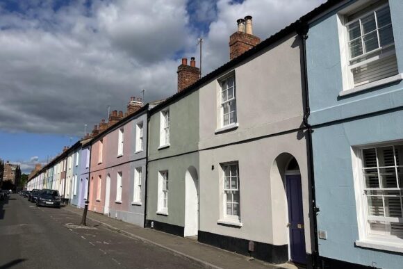 Colourful terraced houses along a quiet residential street in Jericho, Oxford, known for its historic character and creative community.