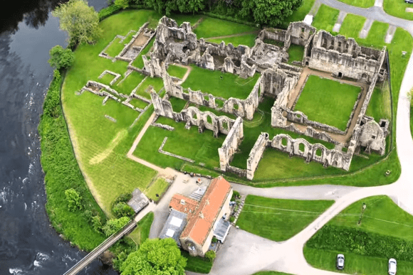 Aerial view of Finchale Priory ruins beside the River Wear, showing the full layout of the medieval complex.