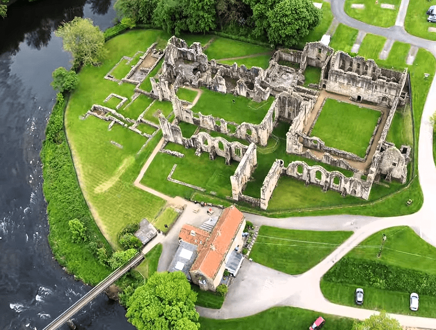 Aerial view of Finchale Priory ruins beside the River Wear, showing the full layout of the medieval complex.