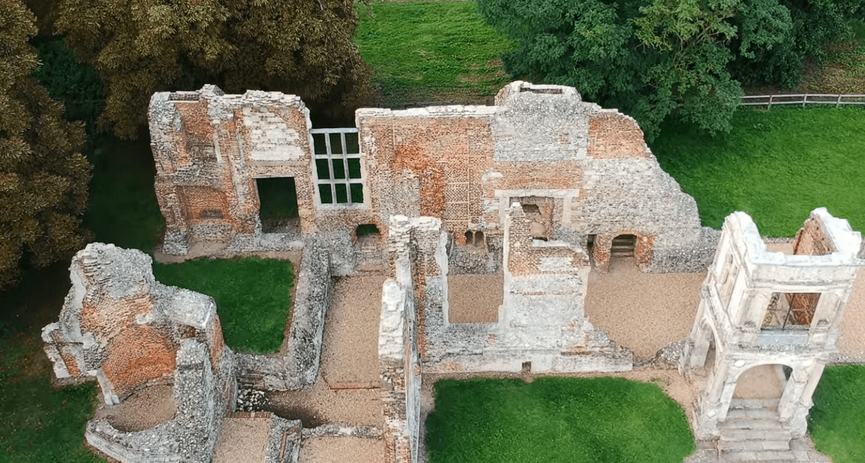 Aerial view of Old Gorhambury House ruins showing brick and stone walls, partial rooms, and surrounding greenery.